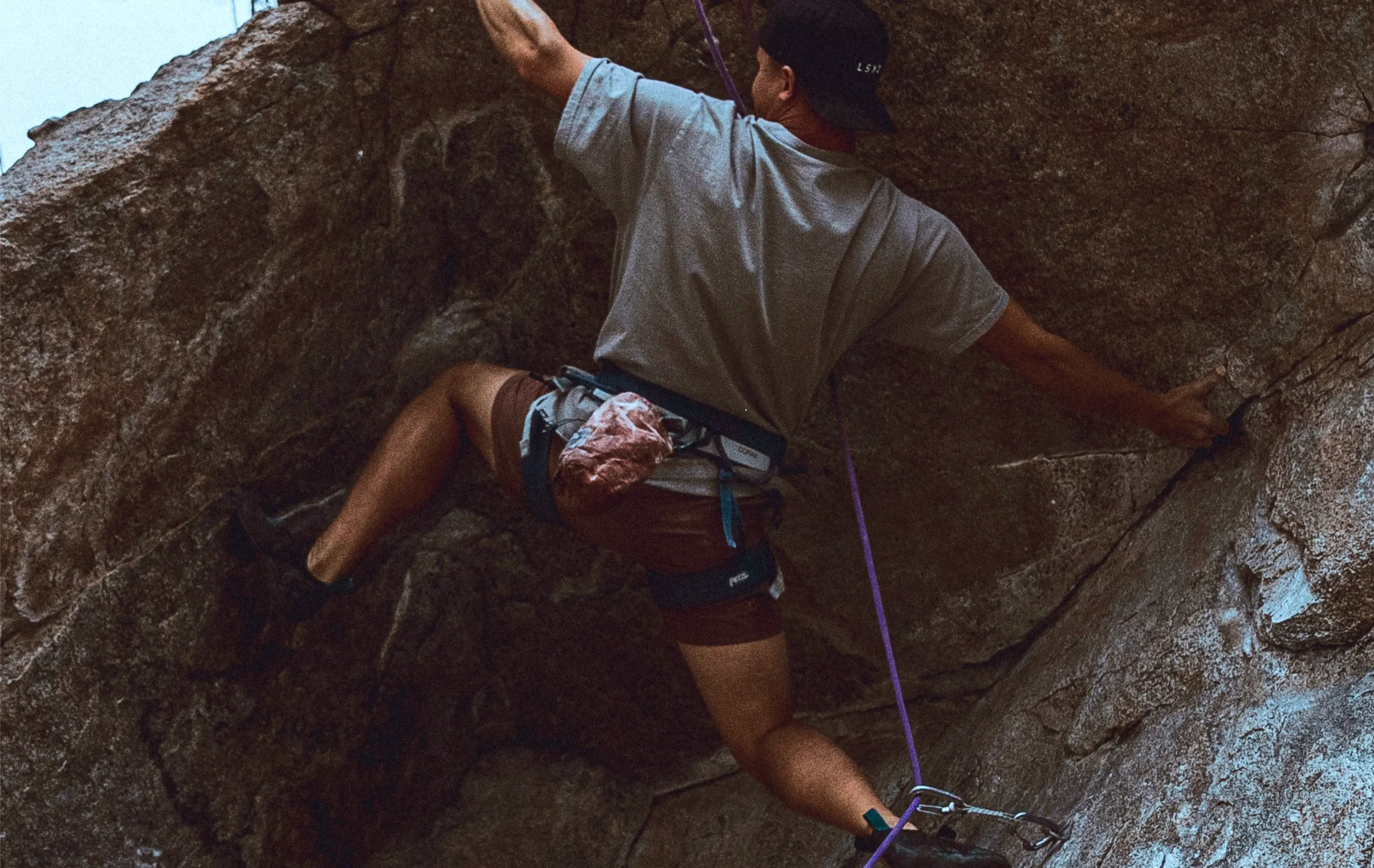 background image of a man rock climbing